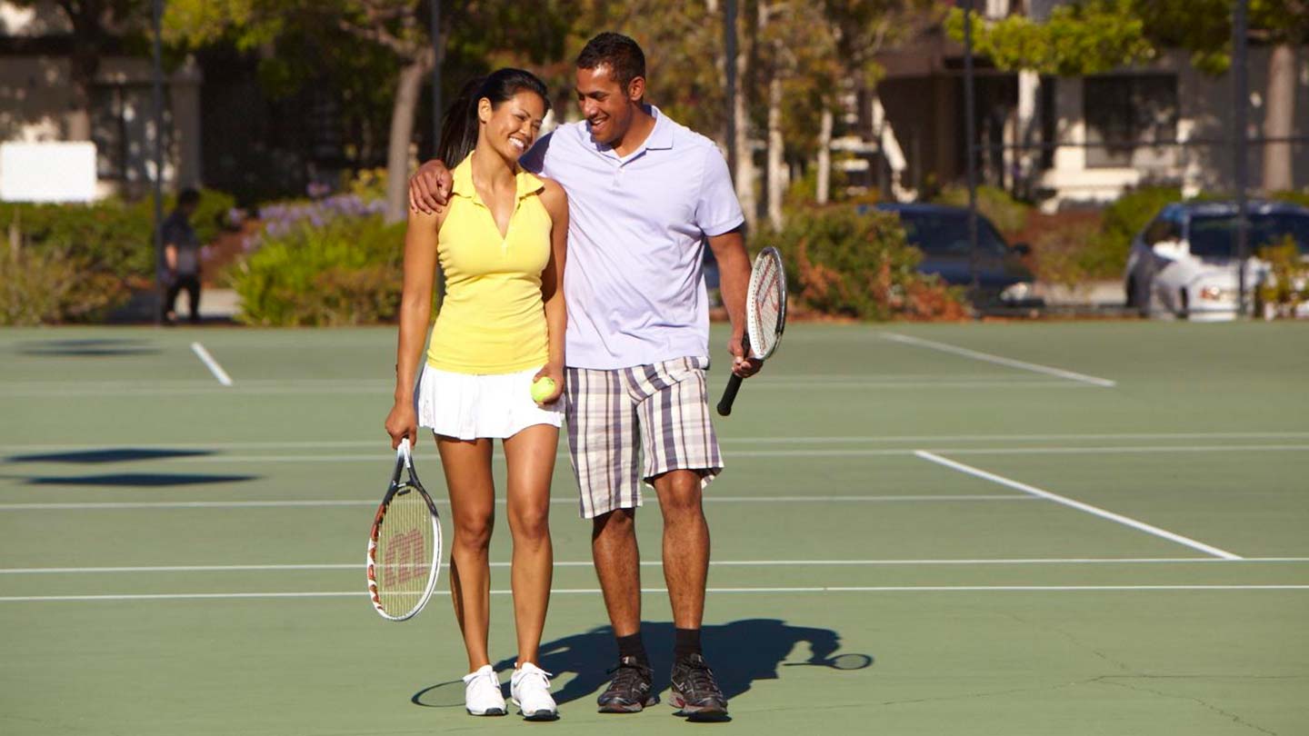 Couple playing tennis